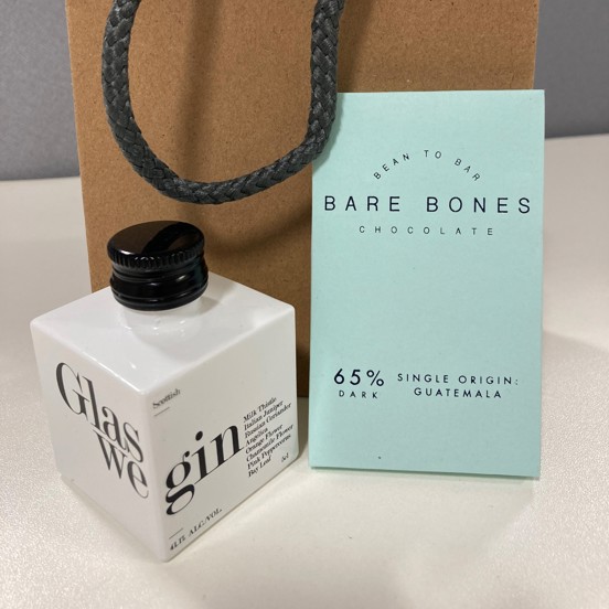 Miniature bottle of Glaswegin, small bar of Barebones chocolate and a gift bag